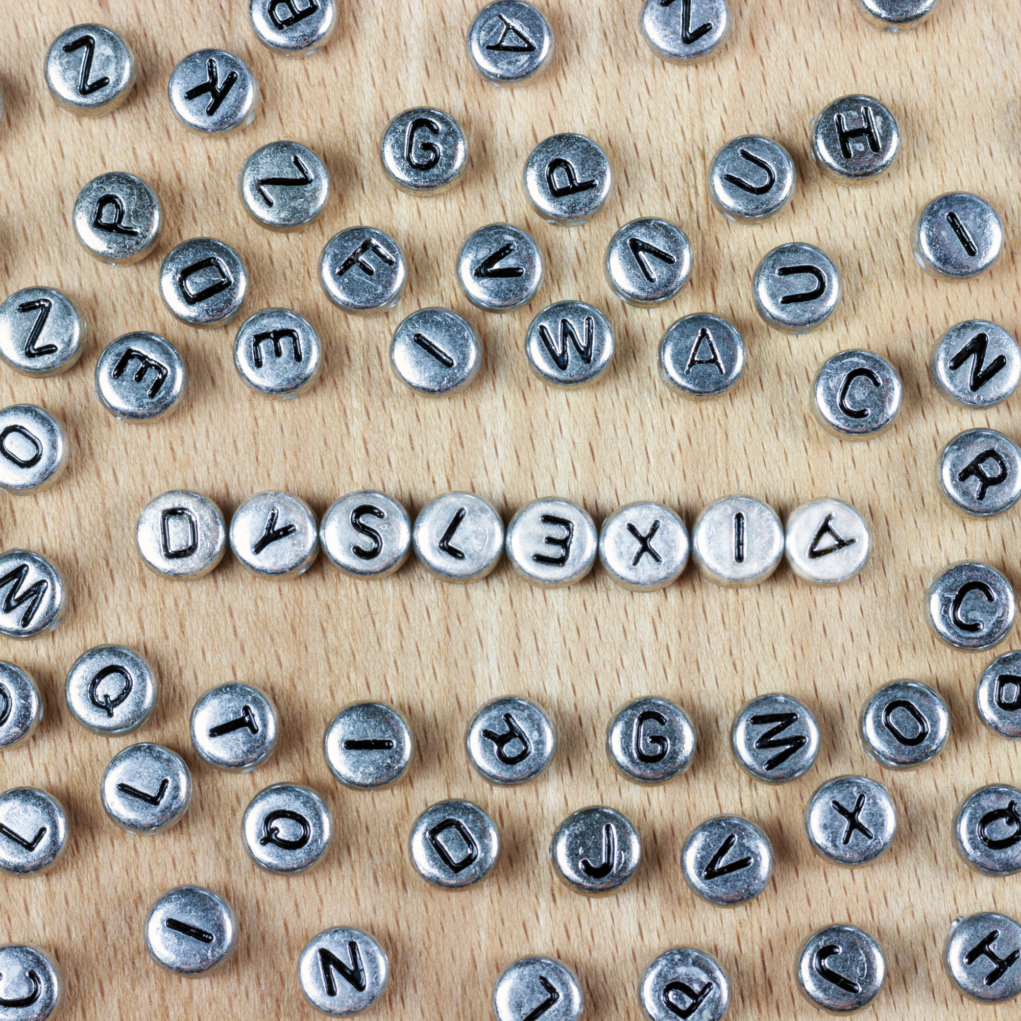 Young boy smiling while reading a book indoors